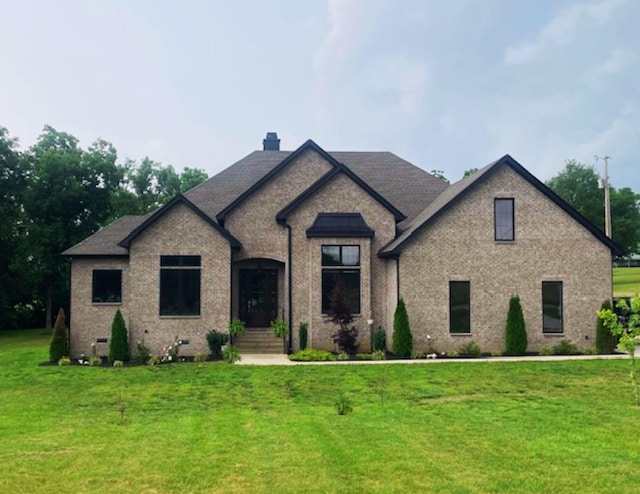 104 Branham Mill Rd, Gallatin, TN 37066 - french provincial home featuring a front lawn, a chimney, and brick siding