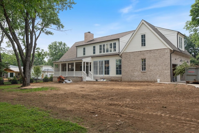 8230 Frontier Ln, Brentwood, TN 37027 - rear view of property featuring a sunroom, a chimney, brick siding, and a shingled roof