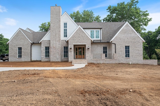 8230 Frontier Ln, Brentwood, TN 37027 - view of front of house featuring a chimney, brick siding, and roof with shingles