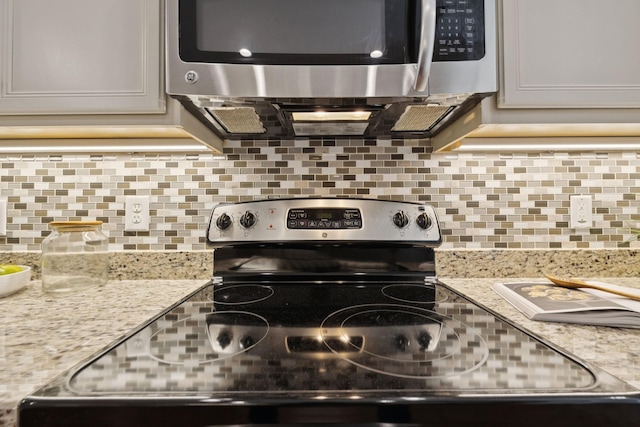 1101 Downs Blvd Unit 295, Franklin, TN 37064 - kitchen with appliances with stainless steel finishes, backsplash, and light stone counters