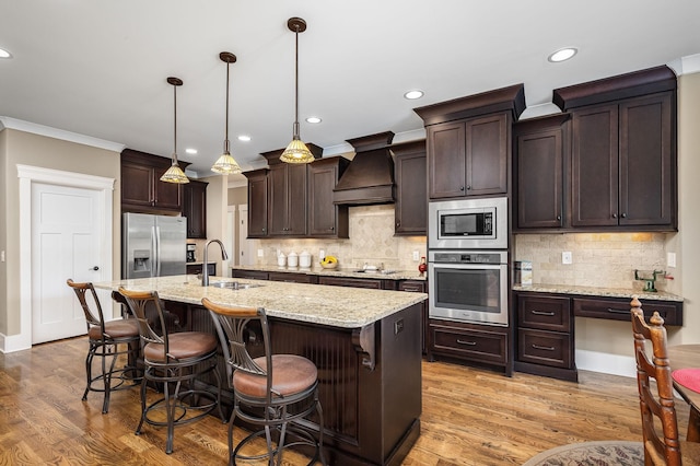 3456 Red Oak Trl, Murfreesboro, TN 37130 - kitchen featuring stainless steel appliances, a sink, premium range hood, dark brown cabinetry, and recessed lighting