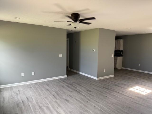 406 New Rock Creek Rd, Tullahoma, TN 37388 - spare room with ceiling fan, baseboards, and wood finished floors