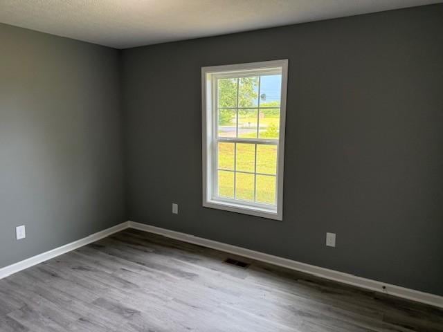 406 New Rock Creek Rd, Tullahoma, TN 37388 - spare room with wood finished floors and baseboards