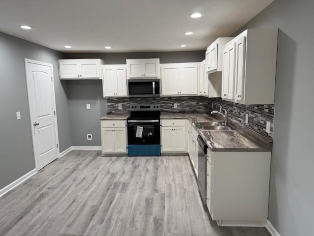 406 New Rock Creek Rd, Tullahoma, TN 37388 - kitchen featuring stainless steel appliances, a sink, dark countertops, decorative backsplash, and recessed lighting