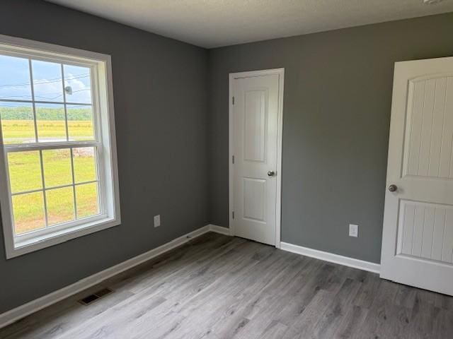 406 New Rock Creek Rd, Tullahoma, TN 37388 - empty room featuring plenty of natural light, wood finished floors, and baseboards