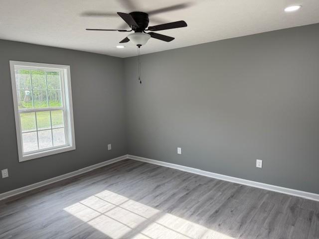 406 New Rock Creek Rd, Tullahoma, TN 37388 - spare room featuring wood finished floors, a ceiling fan, baseboards, and recessed lighting