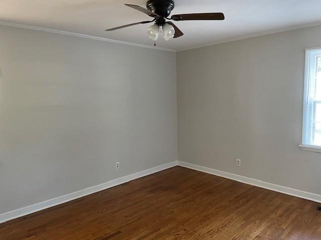 608 Bragg Cir, Tullahoma, TN 37388 - unfurnished room featuring dark wood finished floors, healthy amount of natural light, baseboards, crown molding, and a ceiling fan