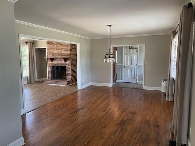 608 Bragg Cir, Tullahoma, TN 37388 - unfurnished living room with dark wood-style floors, baseboards, ornamental molding, and a brick fireplace