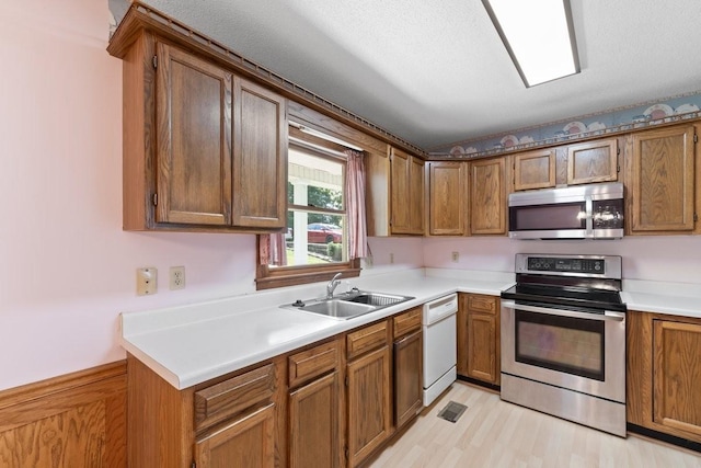 366 Huffman Park Rd, Lynchburg, TN 37352 - kitchen featuring appliances with stainless steel finishes, a sink, light countertops, and brown cabinets