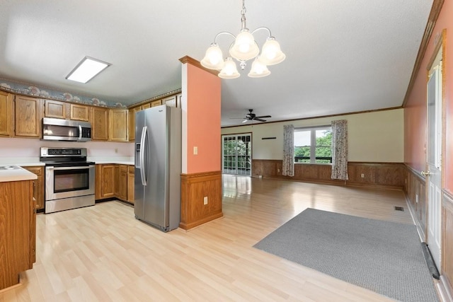 366 Huffman Park Rd, Lynchburg, TN 37352 - kitchen featuring appliances with stainless steel finishes, wainscoting, brown cabinets, a chandelier, and open floor plan