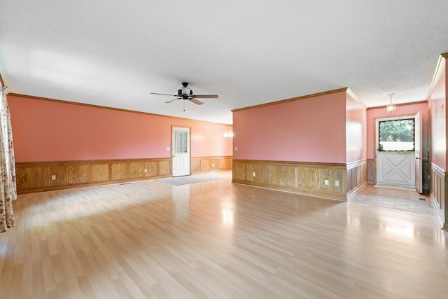 366 Huffman Park Rd, Lynchburg, TN 37352 - spare room featuring light wood finished floors, wainscoting, a ceiling fan, and crown molding
