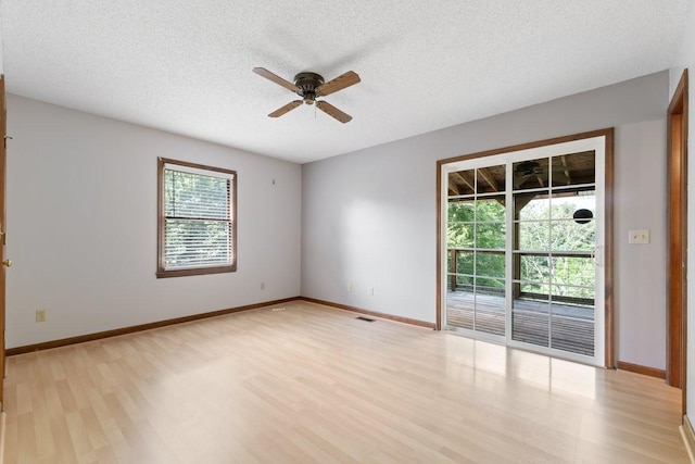 366 Huffman Park Rd, Lynchburg, TN 37352 - unfurnished room with light wood-type flooring, a ceiling fan, a textured ceiling, and baseboards