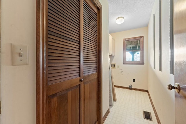 366 Huffman Park Rd, Lynchburg, TN 37352 - washroom featuring cabinet space, light floors, baseboards, and a textured ceiling