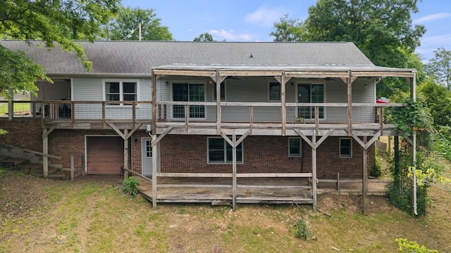 366 Huffman Park Rd, Lynchburg, TN 37352 - back of house featuring an attached garage, brick siding, and roof with shingles