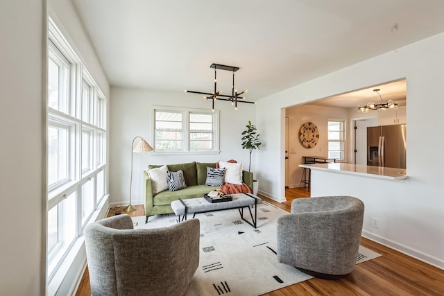 3622 Sabre Dr, Nashville, TN 37211 - living room featuring a chandelier, light wood finished floors, healthy amount of natural light, and baseboards