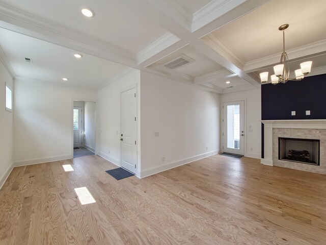 7115 Frances St, Fairview, TN 37062 - unfurnished living room with plenty of natural light, beam ceiling, light wood-style flooring, crown molding, and a chandelier