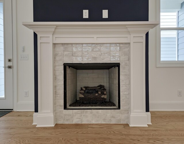 7115 Frances St, Fairview, TN 37062 - detailed view of wood finished floors, a tiled fireplace, and baseboards