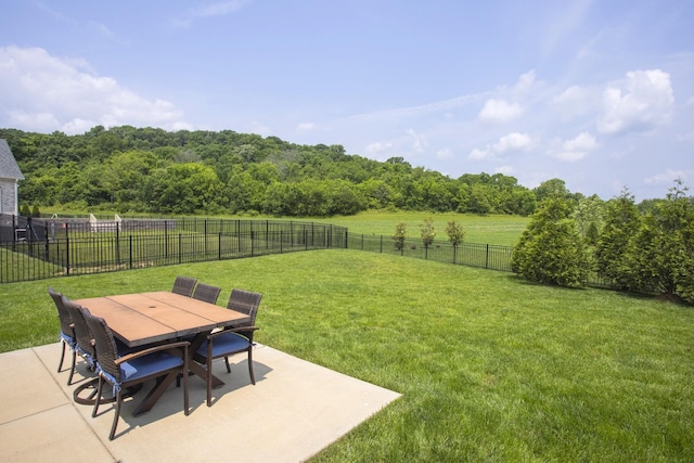 6575 Windmill Dr, College Grove, TN 37046 - view of yard featuring a patio, outdoor dining space, and a forest view