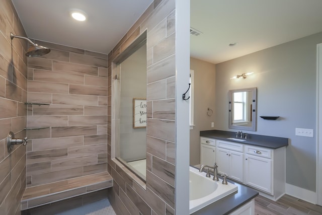 6575 Windmill Dr, College Grove, TN 37046 - full bathroom featuring vanity, tiled shower, recessed lighting, a tub to relax in, and wood finished floors