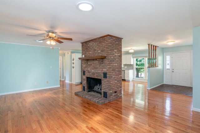 930 Rossview Rd, Clarksville, TN 37043 - unfurnished living room with light wood-style floors, a fireplace, and a ceiling fan