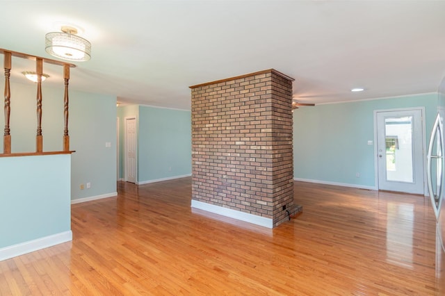 930 Rossview Rd, Clarksville, TN 37043 - unfurnished living room with light wood finished floors, ceiling fan, and crown molding