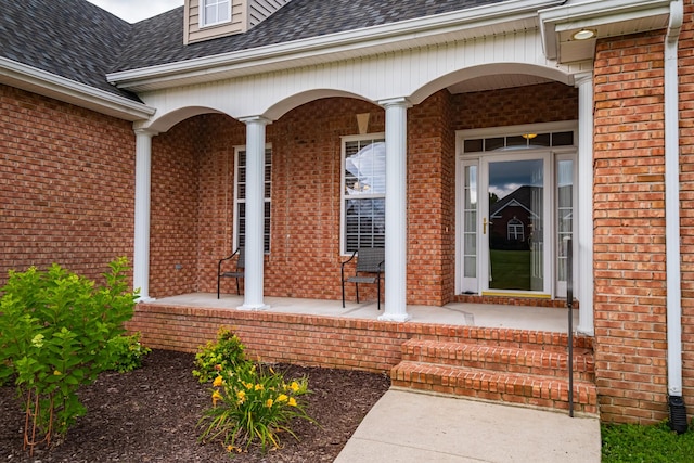 107 Hunters Ct, Tullahoma, TN 37388 - doorway to property with covered porch, brick siding, and roof with shingles