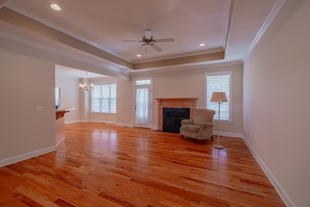 107 Hunters Ct, Tullahoma, TN 37388 - unfurnished living room with a chandelier, a fireplace, a raised ceiling, crown molding, and ceiling fan