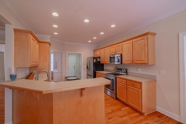 107 Hunters Ct, Tullahoma, TN 37388 - kitchen featuring stainless steel appliances, a kitchen breakfast bar, light brown cabinetry, a peninsula, and light wood-type flooring