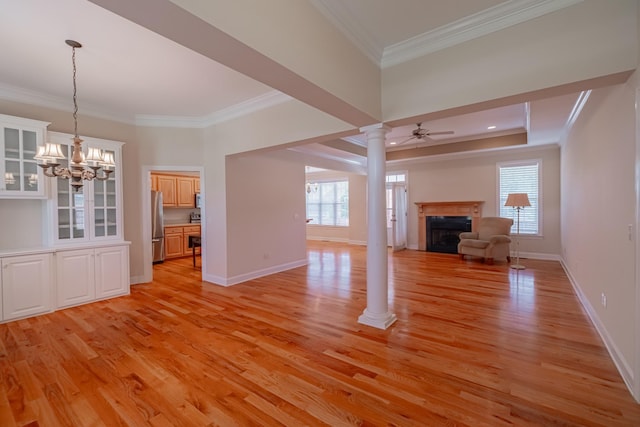 107 Hunters Ct, Tullahoma, TN 37388 - unfurnished living room with ornamental molding, ornate columns, light wood-type flooring, a fireplace, and healthy amount of natural light