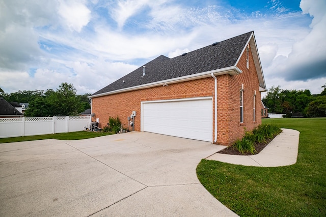 107 Hunters Ct, Tullahoma, TN 37388 - view of side of property featuring brick siding, roof with shingles, driveway, and a garage