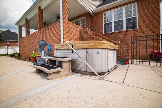 107 Hunters Ct, Tullahoma, TN 37388 - view of property exterior featuring brick siding, a hot tub, ceiling fan, and roof with shingles