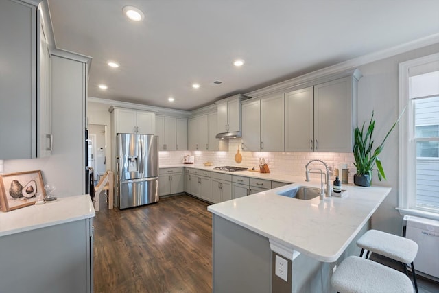 3204 Vinemont Dr, Thompsons Station, TN 37179 - kitchen with appliances with stainless steel finishes, gray cabinetry, a sink, a peninsula, and decorative backsplash