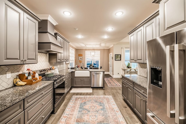 403 Hunter Bryce Ln, Lebanon, TN 37087 - kitchen featuring appliances with stainless steel finishes, gray cabinetry, a sink, tasteful backsplash, and light wood finished floors