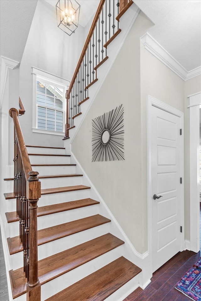 6022 Somerhaven Trl, Hixson, TN 37343 - staircase with wood finished floors, a chandelier, baseboards, and crown molding