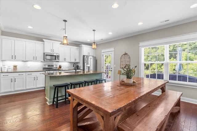 6022 Somerhaven Trl, Hixson, TN 37343 - dining room featuring dark wood-style flooring, ornamental molding, recessed lighting, and baseboards