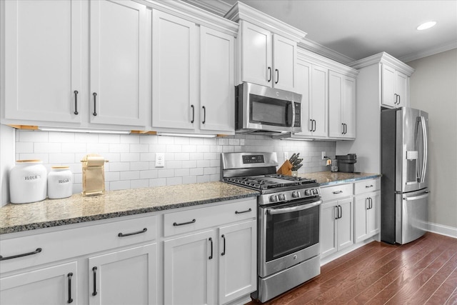 6022 Somerhaven Trl, Hixson, TN 37343 - kitchen featuring appliances with stainless steel finishes, dark wood finished floors, white cabinetry, baseboards, and ornamental molding