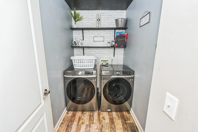 3689 Nadia Dr, Clarksville, TN 37040 - washroom featuring washer and clothes dryer and wood finished floors
