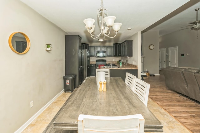 3689 Nadia Dr, Clarksville, TN 37040 - dining space with a chandelier, ceiling fan, and light wood-type flooring