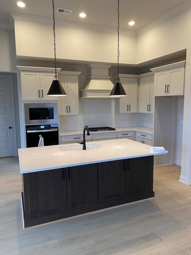 7321 Katherine Ct, Fairview, TN 37062 - kitchen featuring appliances with stainless steel finishes, a sink, crown molding, custom range hood, and light countertops