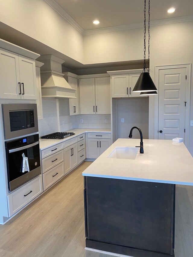 7321 Katherine Ct, Fairview, TN 37062 - kitchen featuring appliances with stainless steel finishes, a sink, ornamental molding, premium range hood, and pendant lighting