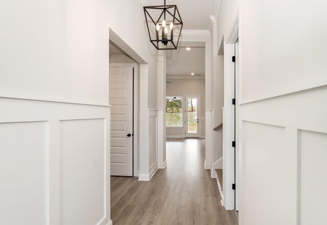 7321 Katherine Ct, Fairview, TN 37062 - corridor with crown molding, a chandelier, light wood finished floors, and baseboards