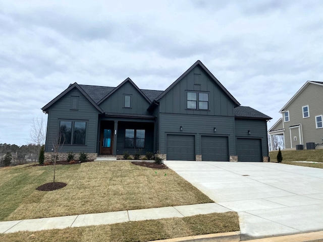 7321 Katherine Ct, Fairview, TN 37062 - view of front of house with board and batten siding, a garage, a front yard, and concrete driveway