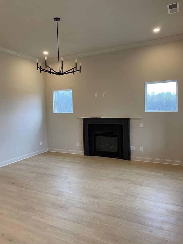 7321 Katherine Ct, Fairview, TN 37062 - unfurnished living room with a chandelier, crown molding, a glass covered fireplace, light wood-style floors, and baseboards