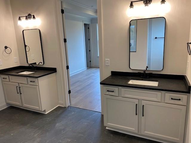 7317 Katherine Ct, Fairview, TN 37062 - bathroom featuring two vanities, crown molding, and baseboards