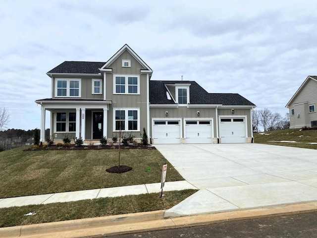 7317 Katherine Ct, Fairview, TN 37062 - view of front of house featuring board and batten siding, a garage, a front lawn, and concrete driveway