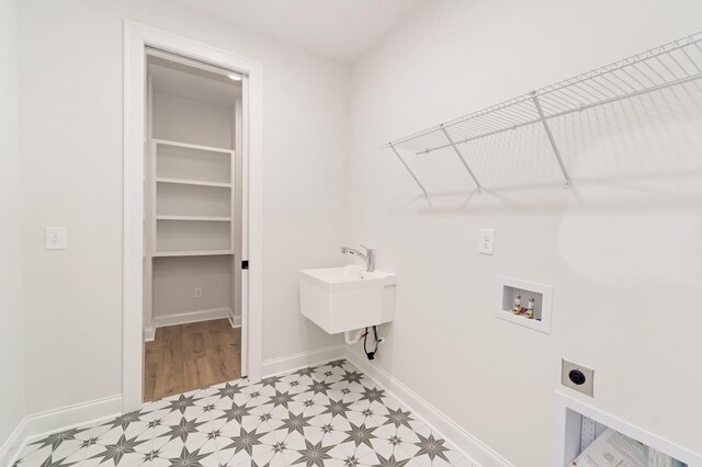 7406 Black Fox Dr, Fairview, TN 37062 - laundry room featuring hookup for an electric dryer, washer hookup, baseboards, and light floors
