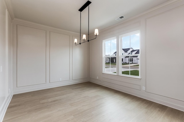 7406 Black Fox Dr, Fairview, TN 37062 - unfurnished dining area featuring a decorative wall, light wood-style floors, a chandelier, and ornamental molding