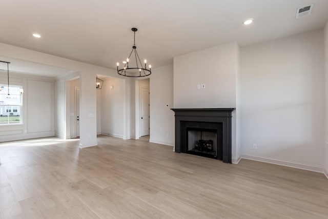 7406 Black Fox Dr, Fairview, TN 37062 - unfurnished living room with a chandelier, light wood finished floors, baseboards, a fireplace, and recessed lighting