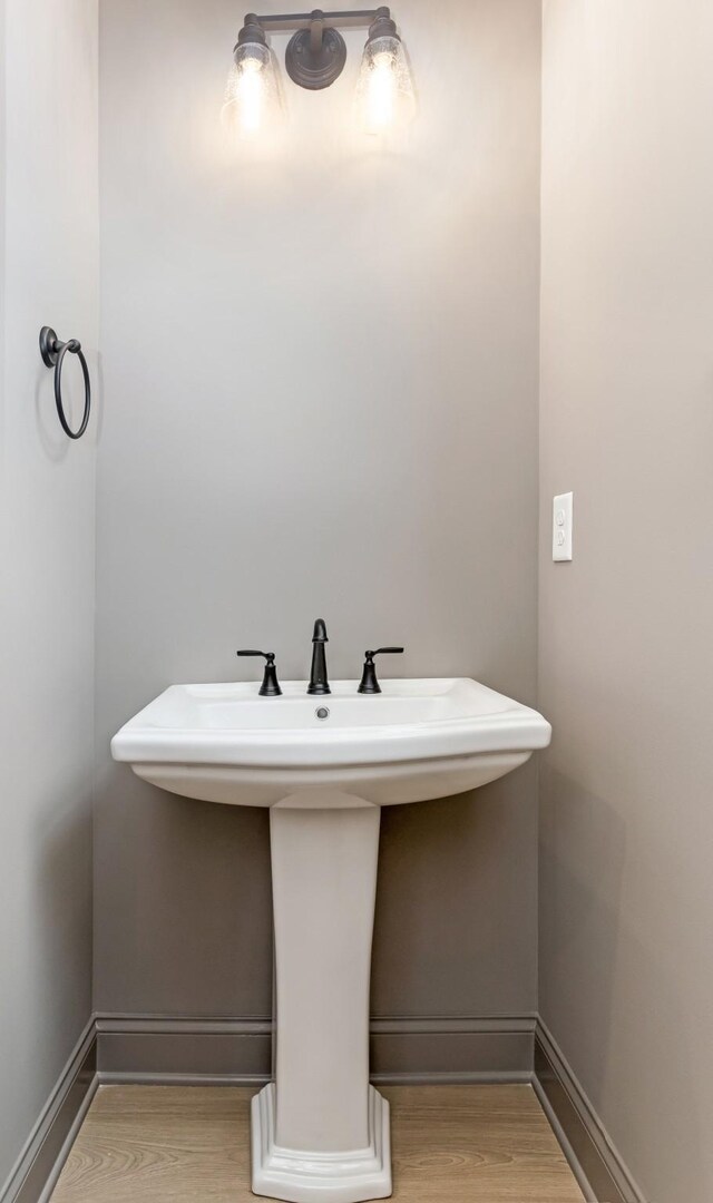 7406 Black Fox Dr, Fairview, TN 37062 - bathroom with wood finished floors, a sink, and baseboards