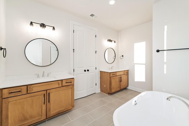 7406 Black Fox Dr, Fairview, TN 37062 - full bathroom with a freestanding tub, two vanities, and tile patterned floors